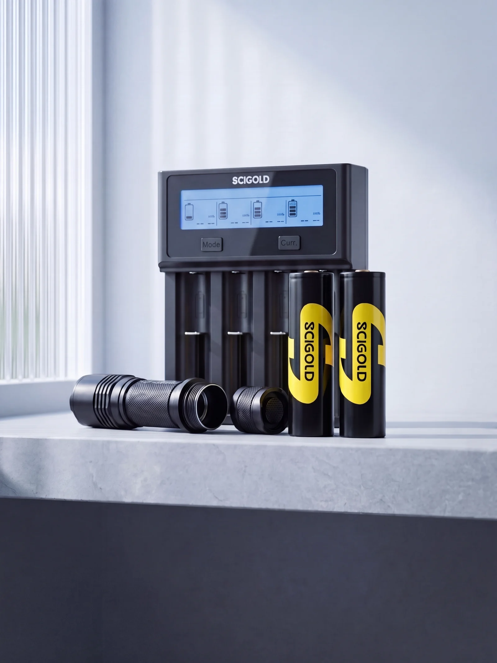 Two SCIGOLD 18650 cells and the four-bay LCD charger on a stone ledge beside an open tactical flashlight