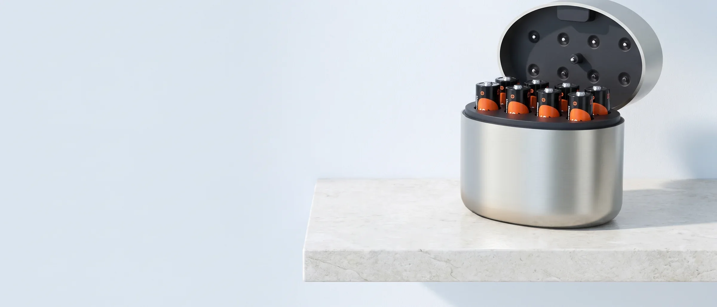 The SCIGOLD Home Charging Case open on a stone shelf with eight SCIGOLD AA cells in its slots