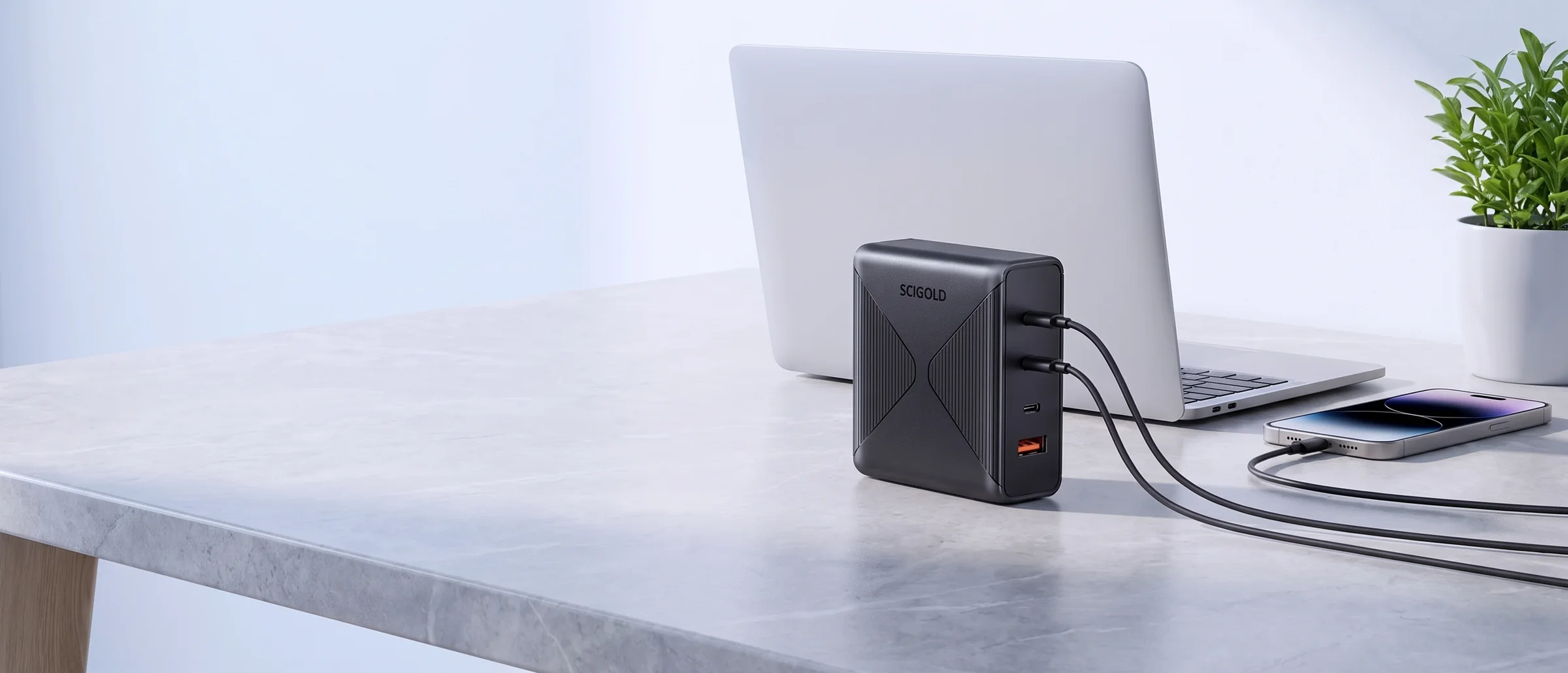 SCIGOLD 100W charger on a desk, charging a laptop and a phone
